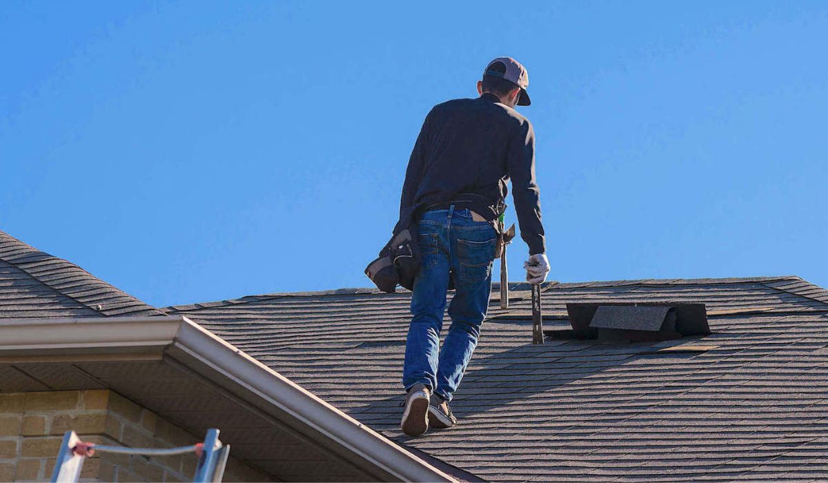 roofer walking on top of a roof