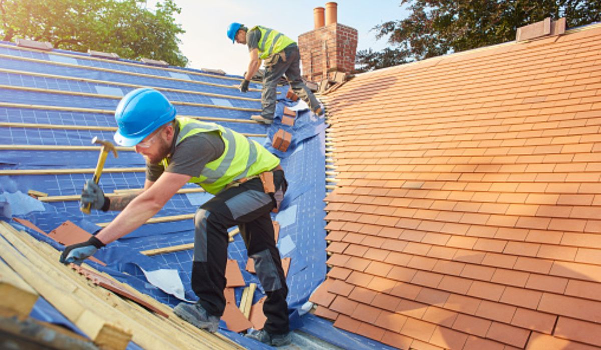 two roofers working on a roof replacement
