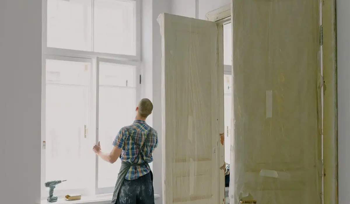 professional renovator installing a window