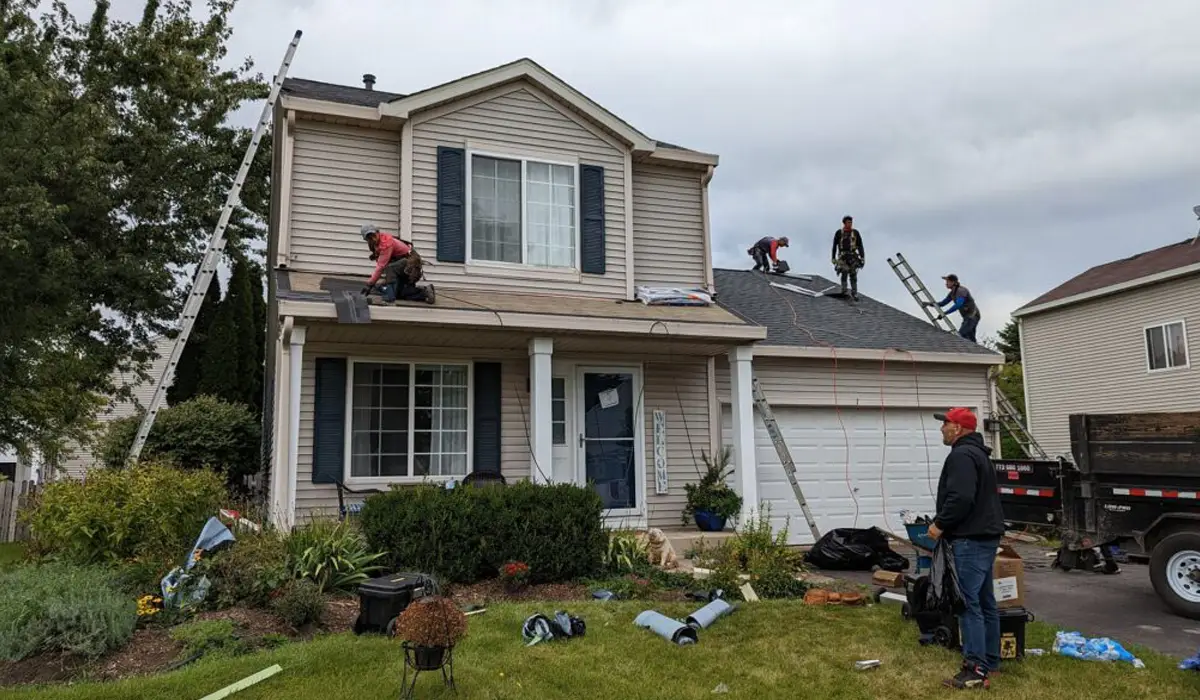 professional roofers repairing the roof of a two storey house