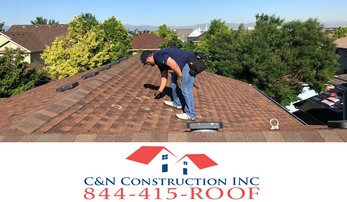 local roofing contractor putting a mark on a roof